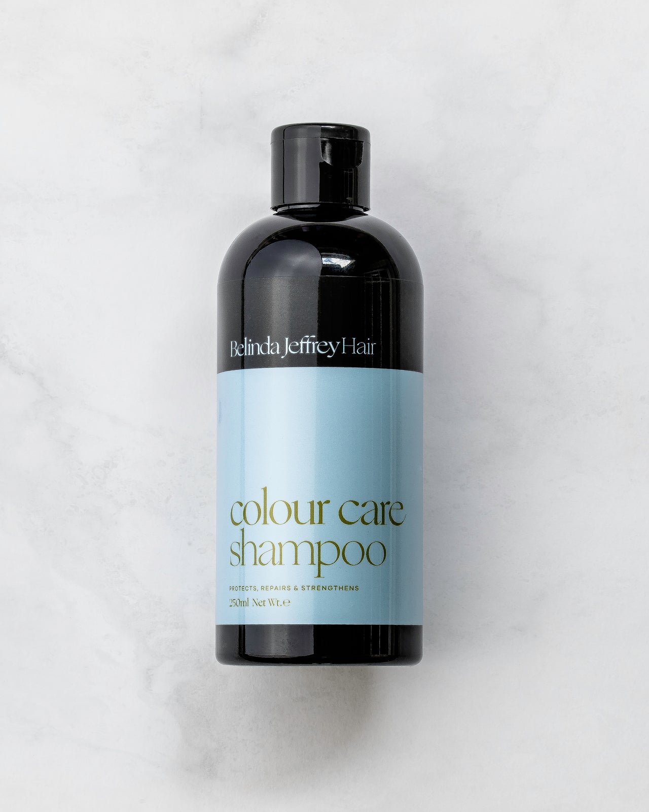 Colour care shampoo by Belinda Jeffrey Hair. Black bottle with a blue label.