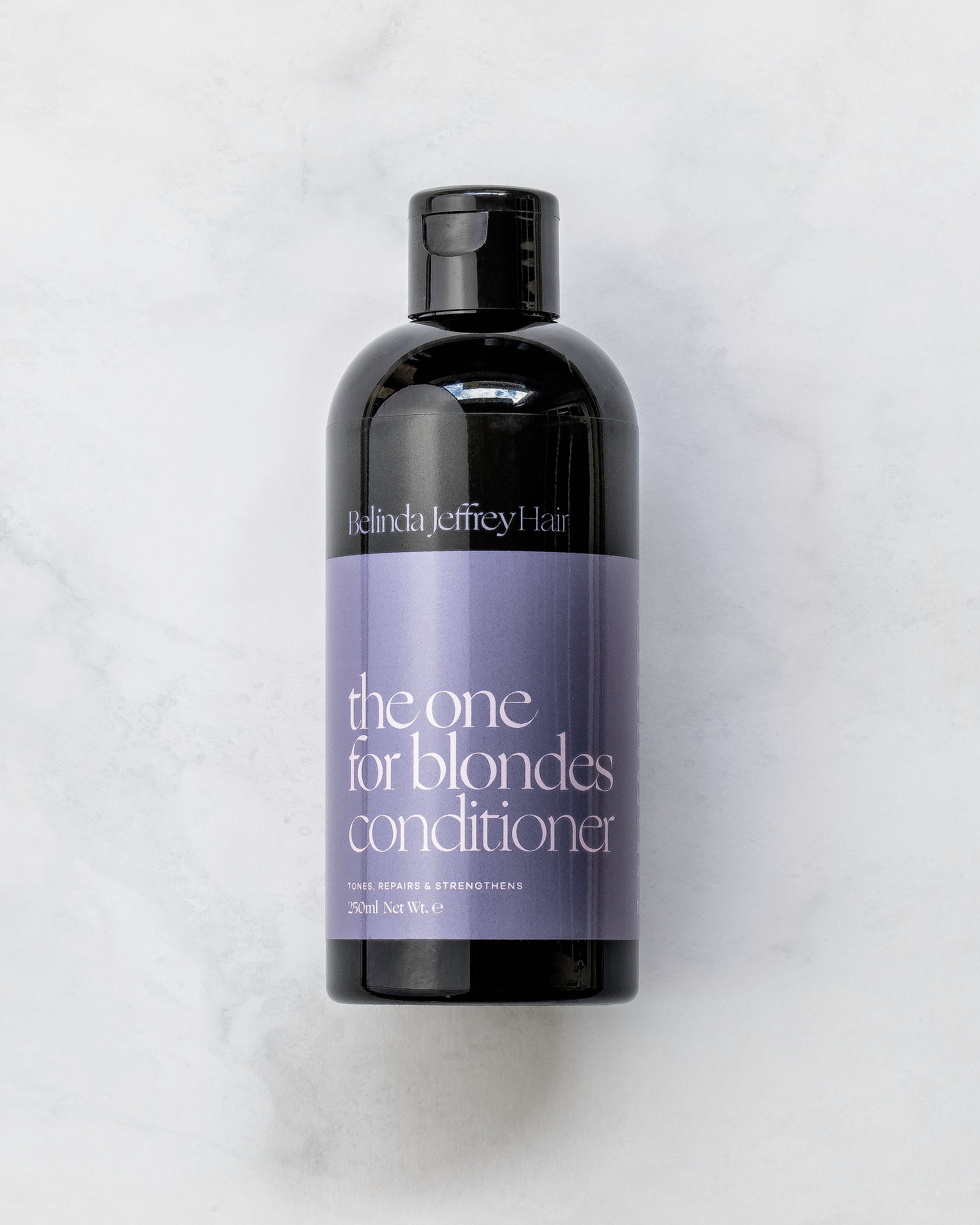 The one for blondes conditioner by Belinda Jeffrey Hair. Black bottle with purple label.