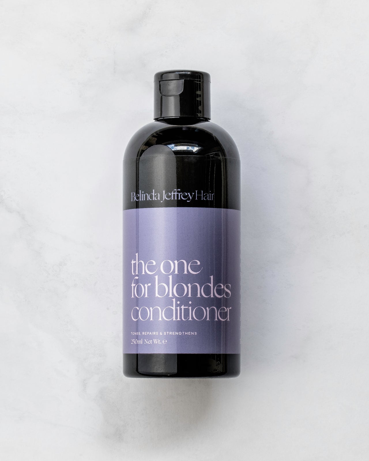 The one for blondes conditioner by Belinda Jeffrey Hair. Black bottle with purple label.